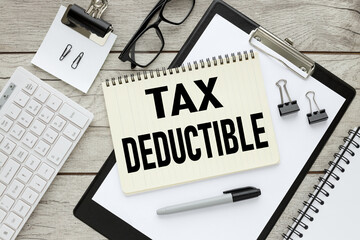 Tax Deductions notepad with text on black folder with clip