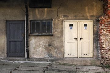 A fragment of an old tenement house and an entrance door to the toilet ...