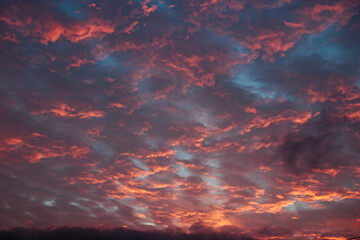 twilight with clouds floating under the blue sky, illuminated by the warm light of the setting sun.