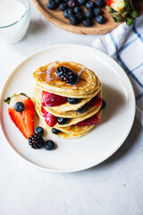 Vanilla pancakes with fruits and berries.  Overhead view.