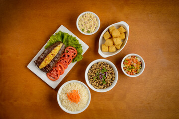 Sun meat and side dishes. Carne de sol, salted steak, typical dish from the Brazilian northeast.