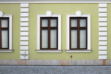 Urban buildings on the street, windows on the background of the building,  Old apartment house after a general renovation, window blinds ...  