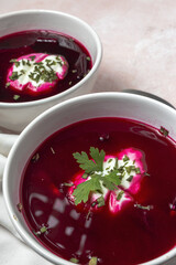 Traditional Ukrainian and Russian national red borscht soup en bol with sour cream and herbs
