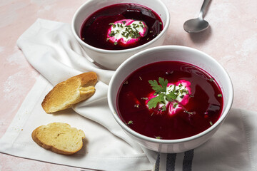 Traditional Ukrainian and Russian national red borscht soup en bol with sour cream and herbs