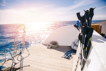 Closeup of flippers with sun, concept banner travel tour on boat snorkeling or diving underwater in sea © Parilov