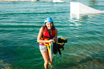 young smiling girl on wake board in water, happy lifestyle people on vacations