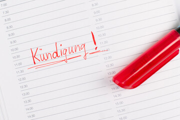 Termination is standing in german language in a calendar, red color and pen, fired from job, unemployeed