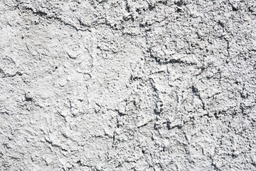 Building wall with roughcast plaster background with grainy effect surface