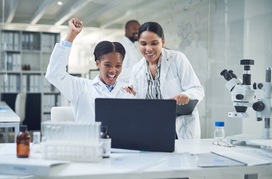 Well Make History With This. Shot Of A Group Of Scientists Cheering While Working In A Lab.