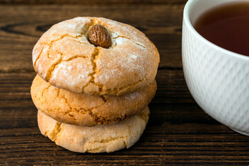 Gluten free italian cookies and a cup of tea. Almond cookies and a cup of tea. Sicilian traditional almond biscuits. Biscotti di mandorla siciliani.
