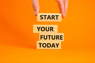 Start your future today symbol. Concept words Start your future today on wood blocks. Businessman hand. Beautiful orange table orange background. Start your future today business concept. Copy space.