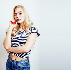 young pretty teenage hipster girl posing emotional happy smiling on white background, lifestyle...