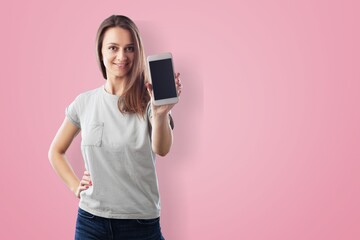 Fototapeta premium Photo of smiling woman looks with happy expression uses mobile phone for chatting online