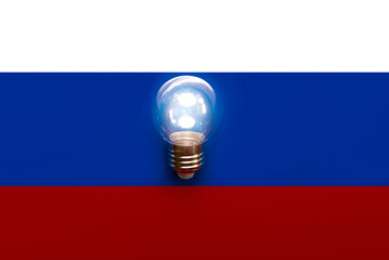 National flag of Russia with light bulb. Electricity and light restrictions concept
