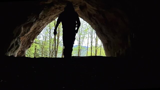 Interior view of a man walking out of the Drachenhoehle (Dragon Cave) in Pernegg an der Mur in Styria, Austria. Cave near mount Rothelstein in Mixnitz in the Grazer Bergland. Grotto. Slow motion
