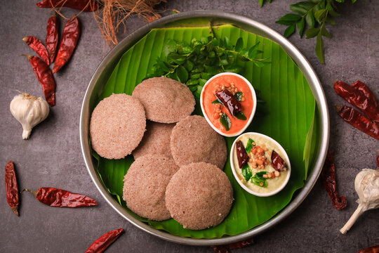 South indian famous break fast raagi idly ,millet idly with chutneys in a plate closeup with selective focus and blur