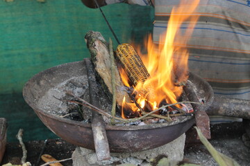 Traditional way to cook a tasty corn in Asia and Latinamerika with a natural fire