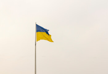 The flag of ukraine is yellow blue on a flagpole against the sky