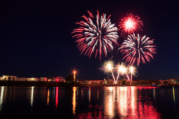Fireworks in the city in the night sky on the banks of the Volga River, Tver, summer, bright multi-colored.