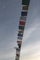 Buddhist famous colorful flags for good luck with prayers fluttering in the blue sky are an ancient way to show the right path 