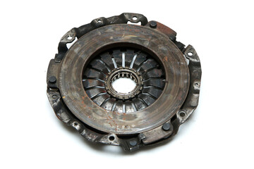The old rusty used clutch from the car engine isolated in a white background. Has to be changed for...