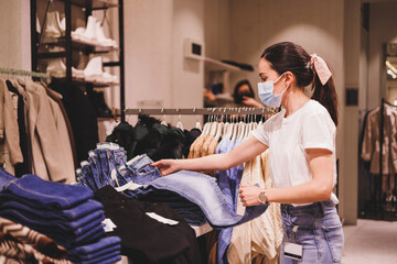 young staff sorting out jeans in clothing store