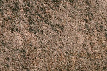 texture of rough bright brown granite boulder rock