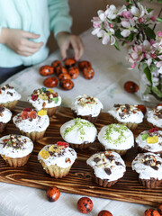 easter concept..  colorful eggs with child hands and blooming branch and easter small cake