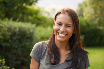 Shes a happy camper. A beautiful young woman smiling outdoors.