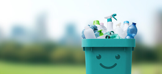 Cute smiling bin full of plastic waste