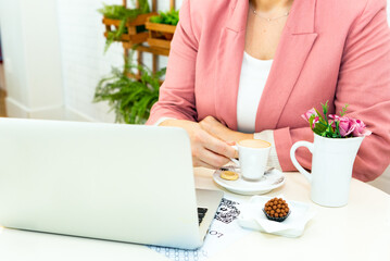 Business, corporate and recruitment concept. Young hipster girl student sit coworking place, cafe, using laptop and drink coffee.