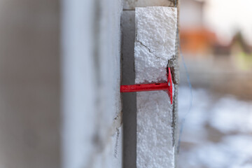 The foam dowel attaches the insulation to the wall. Building insulation