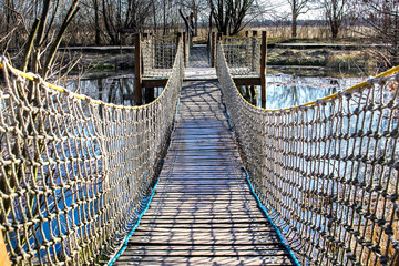 Suspension bridge over the lake water