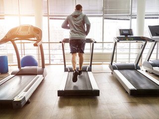 guy jogging on a treadmill in the gym. Fitness, workout and healthy lifestyle