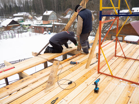 construction of a house in the village.workers make a roof in a private house