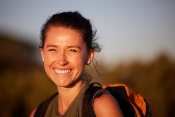Being out in nature makes me happy. Cropped shot of a young woman smiling while out hiking.