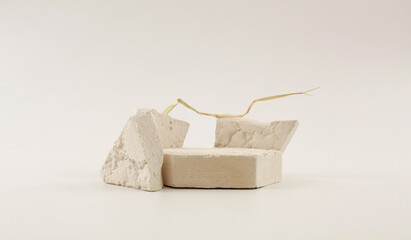 Empty stack of stones platform podium on beige background. Minimal empty display product...