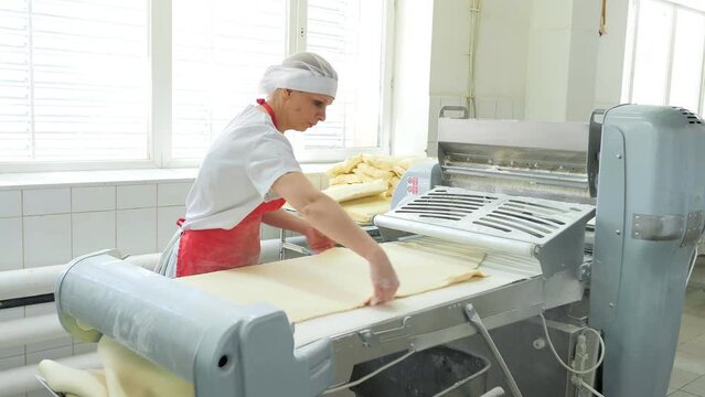 Industrial food factory or bakery.Production of confectionery products. Dough on an automatic conveyor belt, the process of baking cakes at the factory.A confectionery factory or bakery.