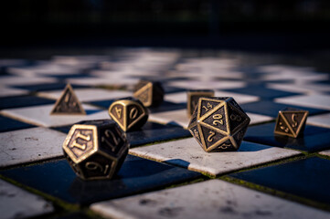 Close-up of a set of roleplaying dice on black and white tiles