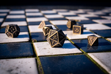 Close-up of a set of roleplaying dice on black and white tiles
