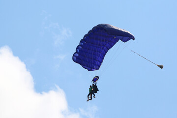 Tandem Skydiver flying wing in a blue sky