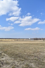 Field Under a Cloudy Blue Sky