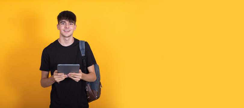 student isolated on background with tablet or computer with backpack - Powered by Adobe