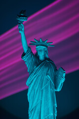 Statue of liberty close up with neon illumination background. USA freedom futuristic concept.