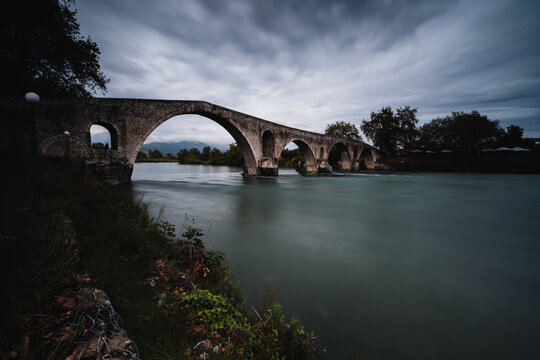 Stone arch bridge over river in Arta city, Greece.