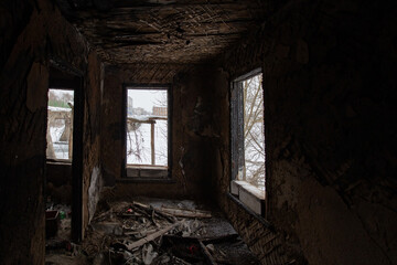 Fototapeta na wymiar Burnt house interior. Consequences of fire or war
