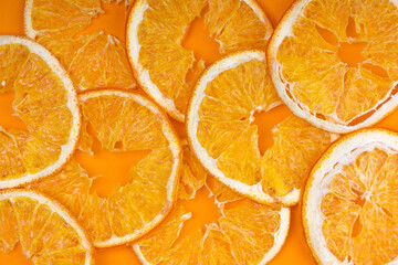 Dried oranges on orange background