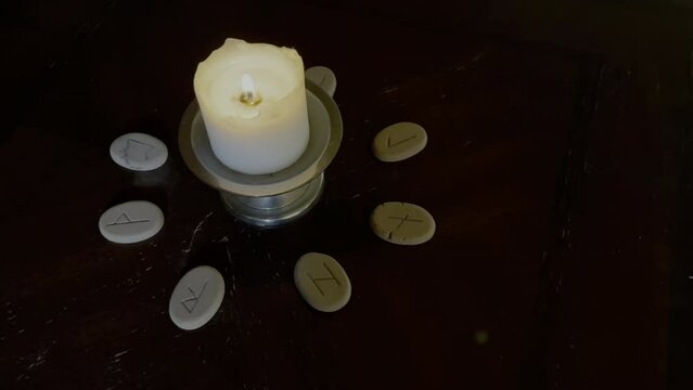 Fortune Telling Runas Round the Candle on the Desk