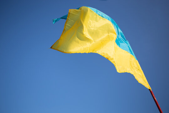 Flag of Ukraine on blue sky background.