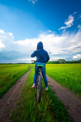 young woman is biking in the nature.